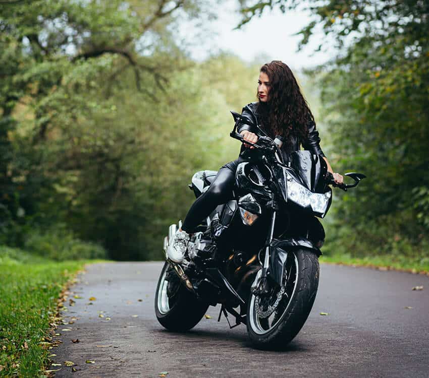 A woman on a black motorbike