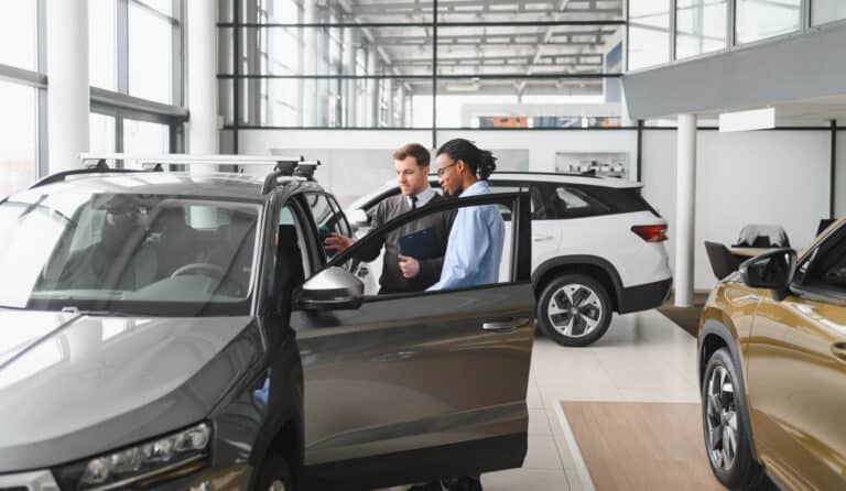 Car Dealer Showing Customer Car
